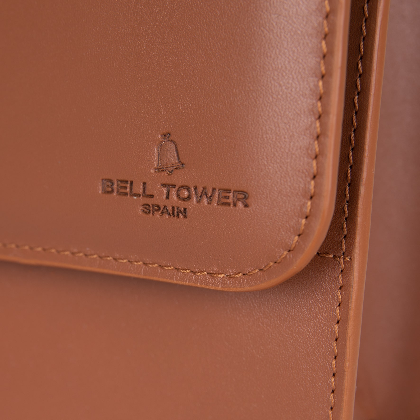 Bell Tower Spain logo embossed on the leather of the Turin briefcase in Persian color.